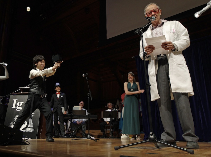 Koji Tsukada, left, fires his invention the "SpeechJammer" at 1986 Nobel Prize laureate for Chemistry Dudley Herschbach during a performance at the Ig Nobel Prize ceremony at Harvard University, in Cambridge, Mass., Thursday, Sept. 20, 2012. The Ig Nobel prize is an award handed out by the Annals of Improbable Research magazine for silly sounding scientific discoveries that often have surprisingly practical applications. (AP Photo/)