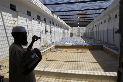 A Libyan man takes pictures of the courtyard of Abu Salim prison, in Tripoli, Libya. in this 2011 photo.