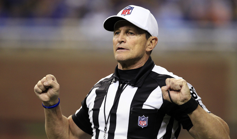Referee Ed Hochuli (85) signals during a game between the Detroit Lions and the San Diego Chargers in Detroit in December 2011. The NFL and referees' union reached a tentative agreement Wednesday to end a three-month lockout that triggered a wave of frustration and anger over replacement officials and threatened to disrupt the rest of the season.