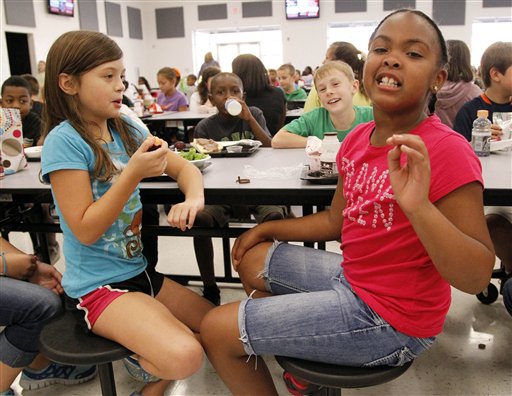 Eastside Elementary school fourth grader Raela Bridges, nine, right, explains what parts of the school lunch she likes to her classmates Grace Bethany, left, Cameron Kinard, back left, and Brock Maddox, back right, all nine, in Clinton, Miss. The Associated Press photo