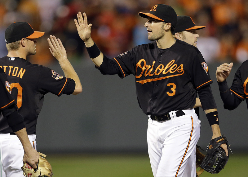 The Orioles' Ryan Flaherty (3) high-fives teammates after a game against the Red Sox in Baltimore on Friday. Flaherty hit a grand slam and a run-scoring double in the Orioles' 9-1 victory.