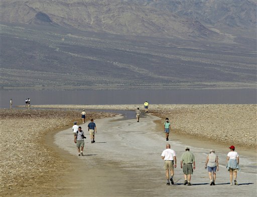 Tourists walk down to the edge of the Badwater Basin, the lowest elevation in the United States, 282 feet below sea level, at Death Valley National Park, Calif. Death Valley is now deemed the world's hottest place.
