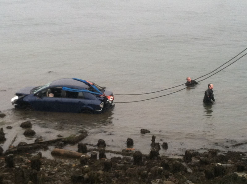 A car is pulled from the water near Ocean Gateway in Portland at the end of India Street.