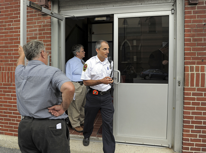 Captain Chris Pirone of the Portland Fire Department exits the Cathedral School on Cumberland Avenue Tuesday after performing checks on the sprinkler and alarm systems.