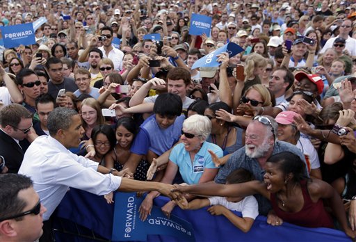 President Barack Obama reaches over to greet supporters during a campaign event at University of Colorado Boulder, Sunday, Sept. 2, 2012, in Boulder, Colo. (AP Photo/Pablo Martinez Monsivais)