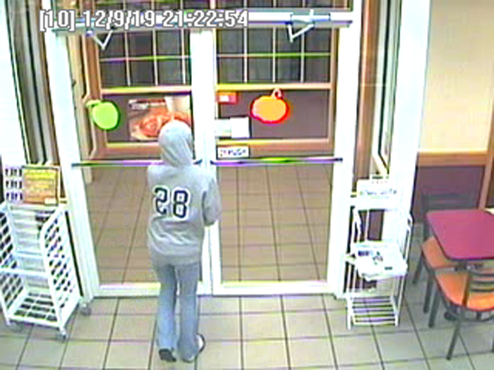 Surveillance image shows robbery suspect leaving the store.