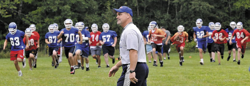 In this Aug. 16, 2010, photo, Messalonskee High School football players begin the first day of practice as then-head coach Wes Littlefield conducts drills.