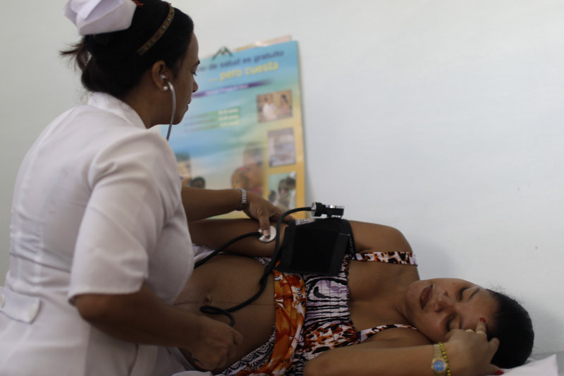 A nurse checks a pregnant woman’s blood pressure at a government-run health clinic in Havana. An Associated Press article on health care in Cuba overlooks both the sector’s accomplishments and the drawbacks of the U.S. system, a reader says.