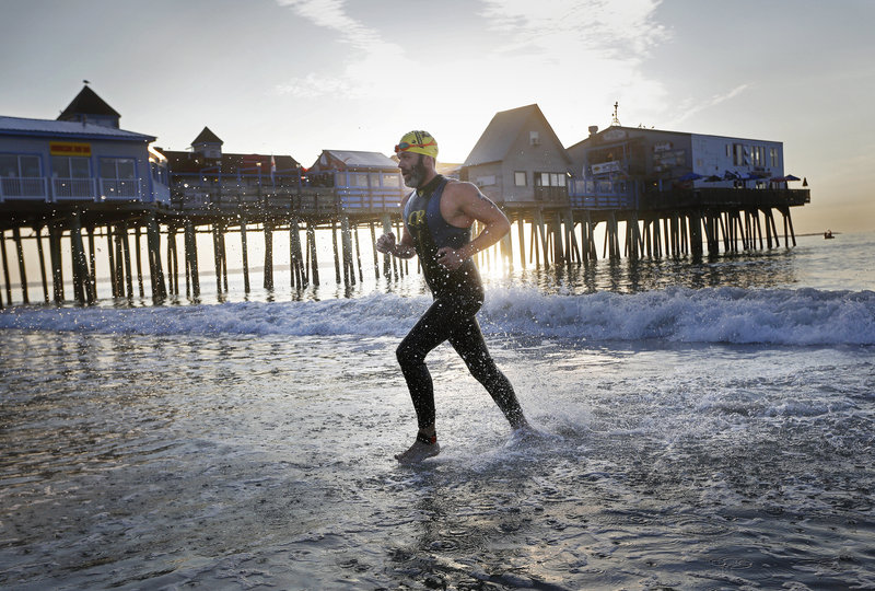 Vinny Johnson of North Berwick exits the water during the Revolution3 triathlon in Old Orchard Beach on Aug. 26. The Portland Press Herald “missed the opportunity to focus on the athleticism demonstrated” during the event by publishing its coverage in the news pages instead of the sports section, readers say.