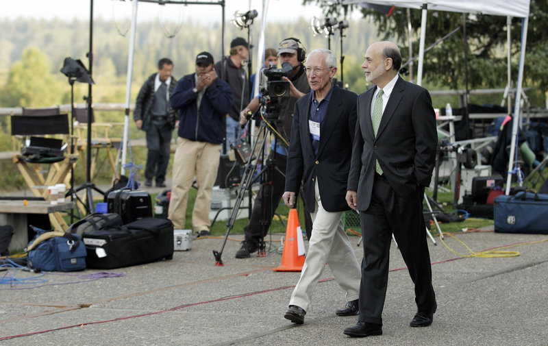 Federal Reserve Chairman Ben Bernanke, right, and Bank of Israel Gov. Stanley Fischer walk past TV cameras Friday outside of the Jackson Hole Economic Symposium at Grand Teton National Park in Wyoming.