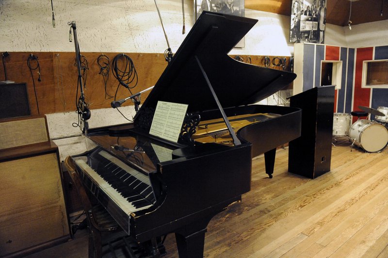 An 1877 Steinway grand piano is seen in a Motown recording studio in Detroit. Ex-Beatle Paul McCartney, below, will soon perform on one that he paid to have restored.