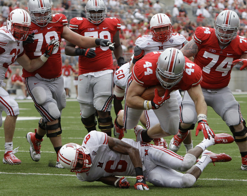 Zach Boren of Ohio State dives over D.J. Brown to score a touchdown during the Buckeyes’ 56-10 win Saturday over Miami (Ohio).