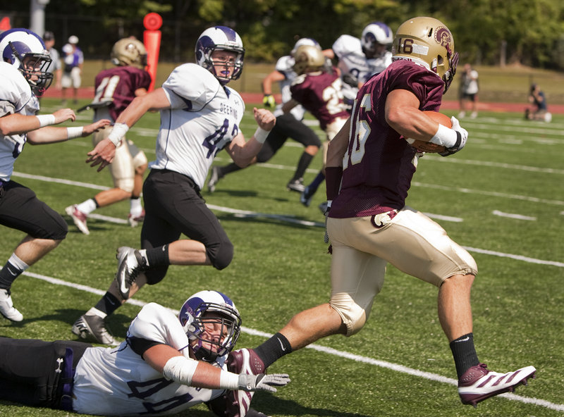 Andrew Libby of Thornton Academy eludes a foot tackle from Dominic Esposito-Martin of Deering to score a second-quarter touchdown on a punt return, giving the Golden Trojans a 17-0 lead Saturday on the way to a 44-14 victory at Saco.