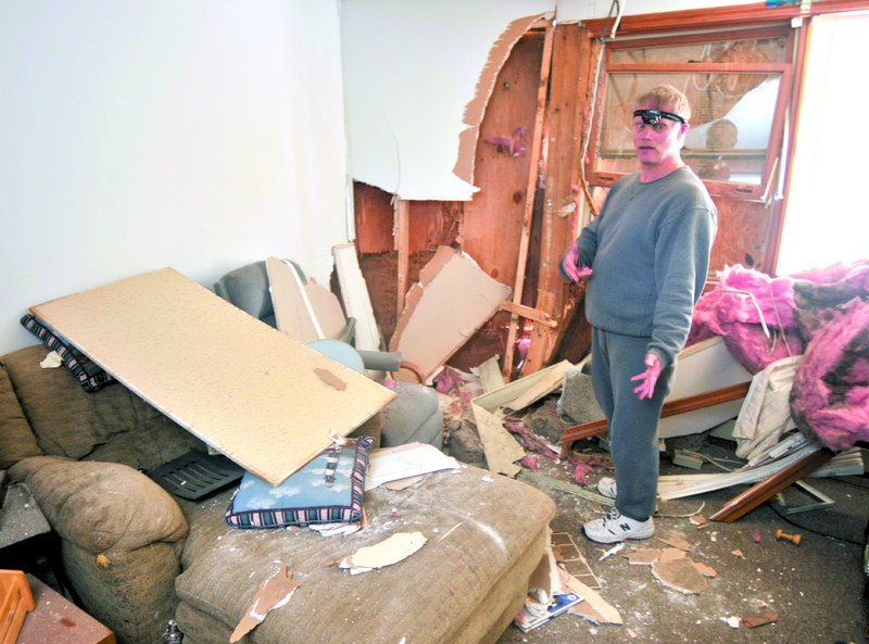 Jim Pinkham stands in his shattered apartment on Saturday morning, describing how a vehicle crashed through the wall of his street-level living room at 36 Water St. in Augusta on Friday evening. Pinkham suffered only a bruised arm from flying debris in the accident.