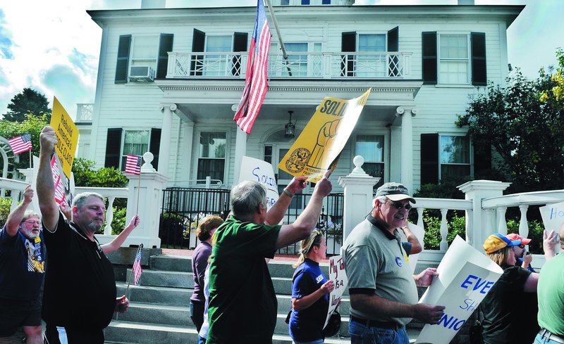 Labor supporters march Sunday in front of the Blaine House in Augusta during a Labor Day celebration with workers from Maine unions. Marchers walked around the governor’s mansion and then gathered in Capitol Park for a cookout. Monday is Labor Day.