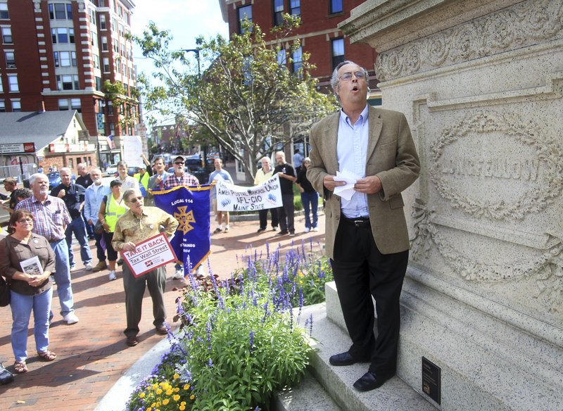 Harlan Baker reads a poem for union members at Longfellow Square after the labor breakfast. Some said they attended because they hoped the rally would offer solutions to what they viewed as limited opportunities afforded to the middle class.