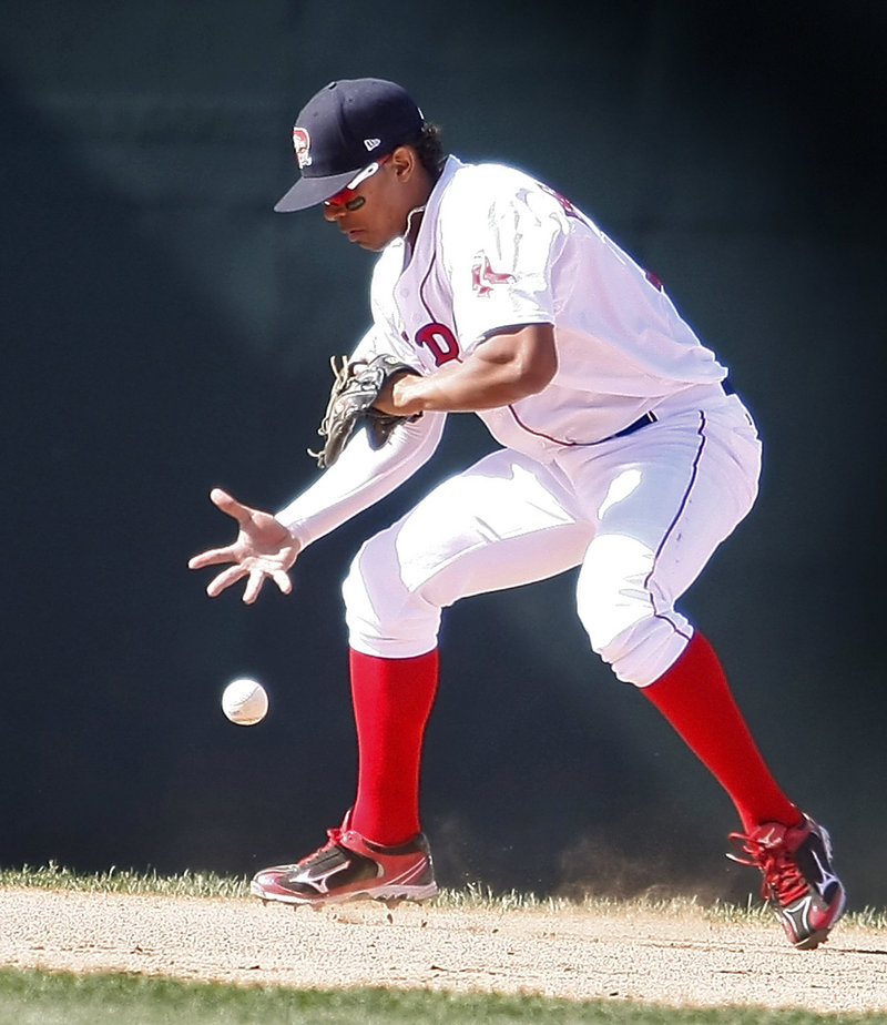 Sea Dogs shortstop Xander Bogaerts struggles to contain a grounder in Monday’s game at Hadlock Field. Bogaerts was charged with an error.