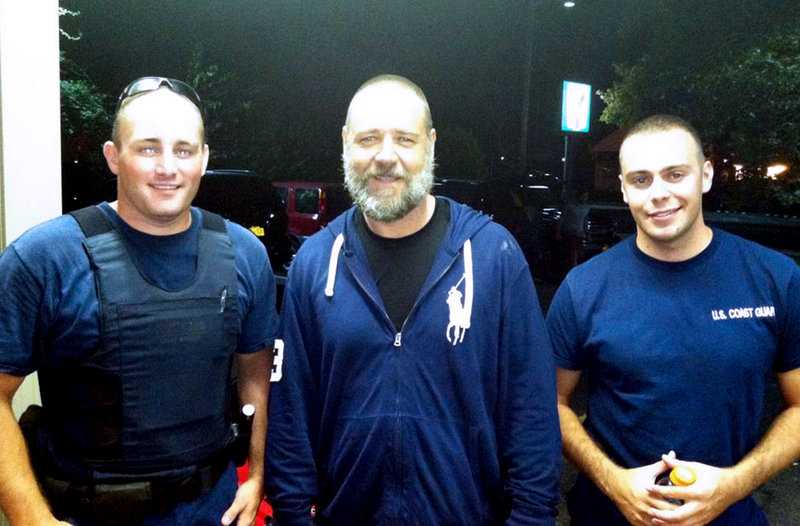 Russell Crowe, center, stands with Coast Guard petty officers Robert Swieciki, left, and Thomas Watson on Sunday. Crowe and a friend lost their bearings while kayaking in Long Island Sound Sunday and flagged down the Coast Guard for assistance.