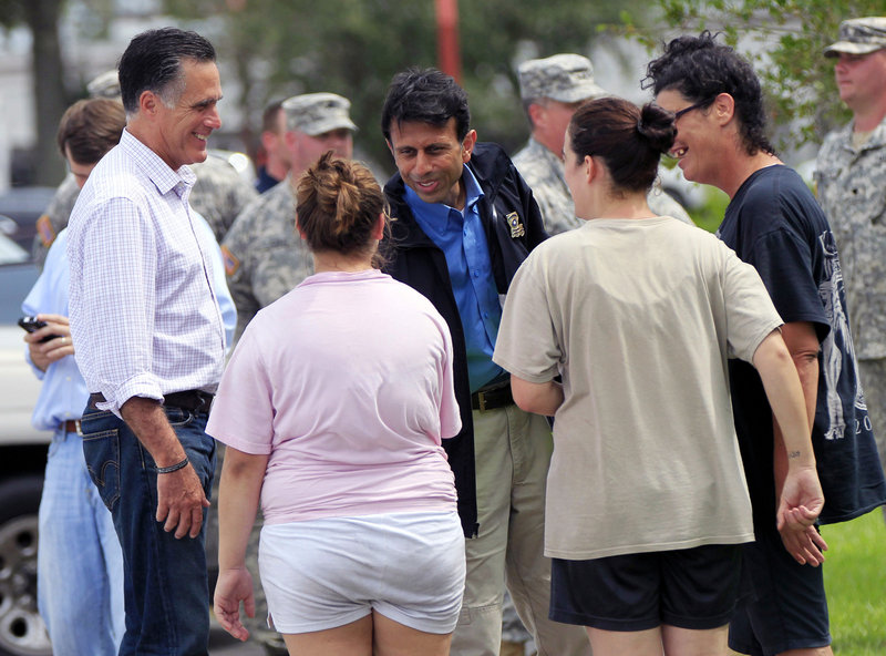 Republican presidential candidate Mitt Romney, left, and Jindal greet residents displaced by Isaac on Friday in Lafitte, La.