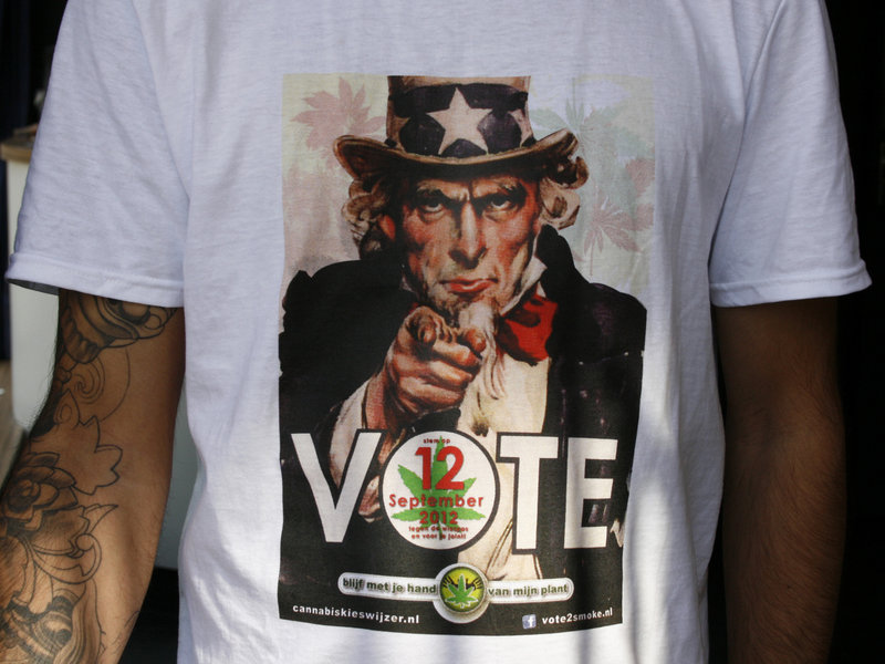A T-shirt emblazoned with a modified Uncle Sam-style poster calls on smokers to “Vote against the weed pass on Sept. 12.” Under the new system, coffee shops become members-only clubs and only Dutch residents can apply for a pass to get in.
