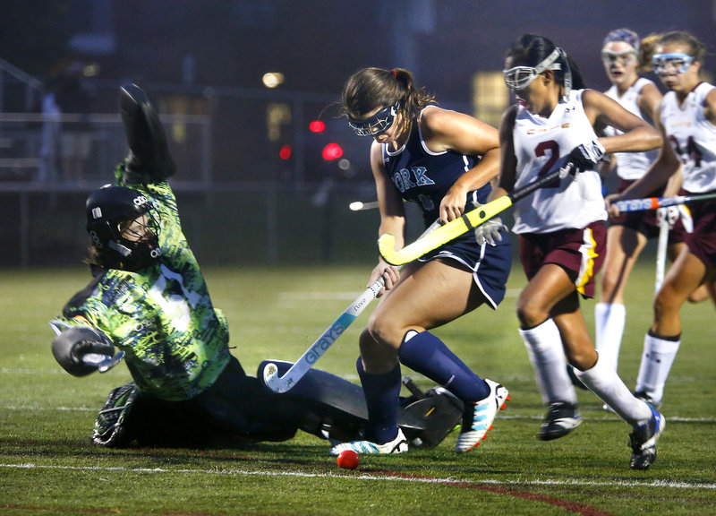 Cape Elizabeth goalie Julianne Ayers slides to stop a scoring bid by Madeline LeRoux of York during their Western Maine Conference field hockey game Tuesday night. York emerged with a 2-1 victory on a goal by Taylor Simpson.