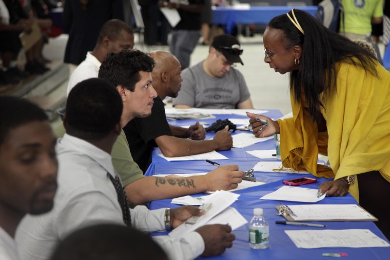 Job seekers fill out applications at a job fair in New York. Unemployment is still over 8 percent, but down from 10 percent in 2010. Will voters go with the number, or the trend, in November?