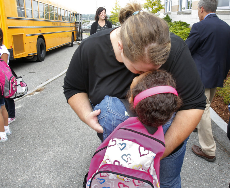 Kate Nelson hugs her daughter Kerra Brown before the first grader heads into Eat End School on Thursday, Sept. 6, 2012.