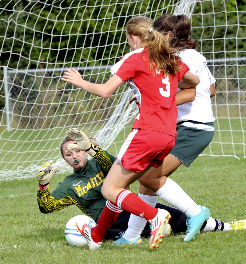 McAuley goalie Molly Miller makes a save as Sanford’s Rachel Fink, 3, closes in for a possible rebound. Sanford, now known as the Spartans, breezed to a 7-2 win.