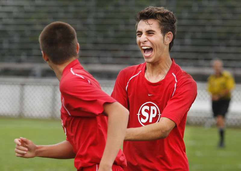 Damjan Draskovic, right, celebrates Thursday with teammate Robert Graff after Graff scored his second goal for South Portland in the second half of a 3-1 victory against Biddeford.