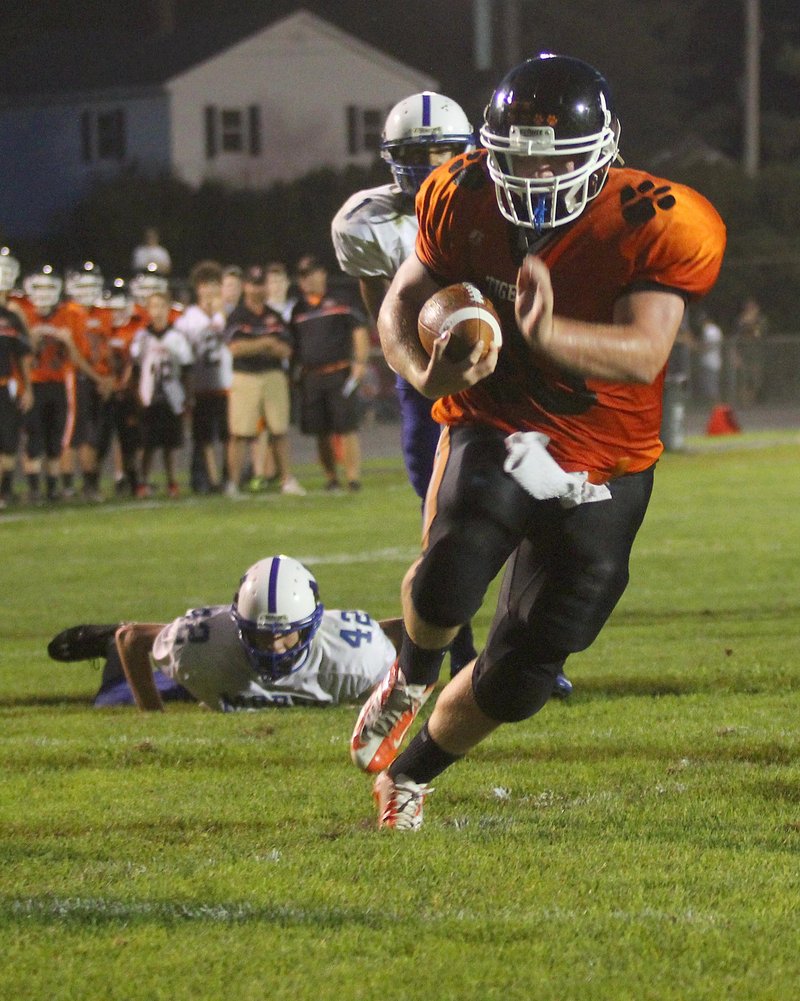 Seth Wing of Gardiner finds a huge hole up the middle Friday night to score on a 9-yard run in the second quarter and give the Tigers a 28-0 lead against Morse. Gardiner went on to a 31-8 victory at home.