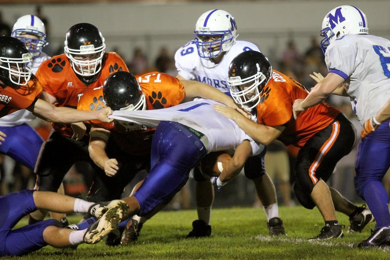 D'Vaughn Meyers of Morse gets his shirt pulled Friday night. Mitch Chesley makes the tackle for Gardiner, which won, 31-8.