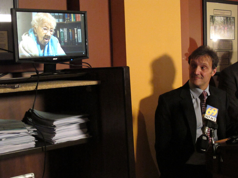 Viviette Applewhite, 93, a plaintiff in a lawsuit against Pennsylvania’s voter identification law, speaks in a video played at a news conference in May in Harrisburg, as attorney Witold Walczak of the American Civil Liberties Union listens. The case is headed for the state supreme court.