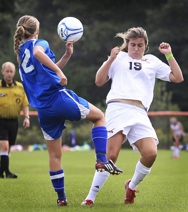 Libby Arford, right, of Brunswick attempts to block a shot by Sonja Robert of Mt. Ararat. Brunswick took command with three goals in the first 20 minutes.