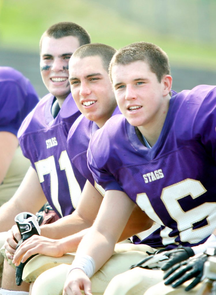 With their team leading 42-0 after three quarters, the Cheverus starters – including Matt Cushing, left, Jackson McMann, middle, and Mike Flaherty – watched from the bench in the fourth quarter while the reserves got their chance for some varsity experience.