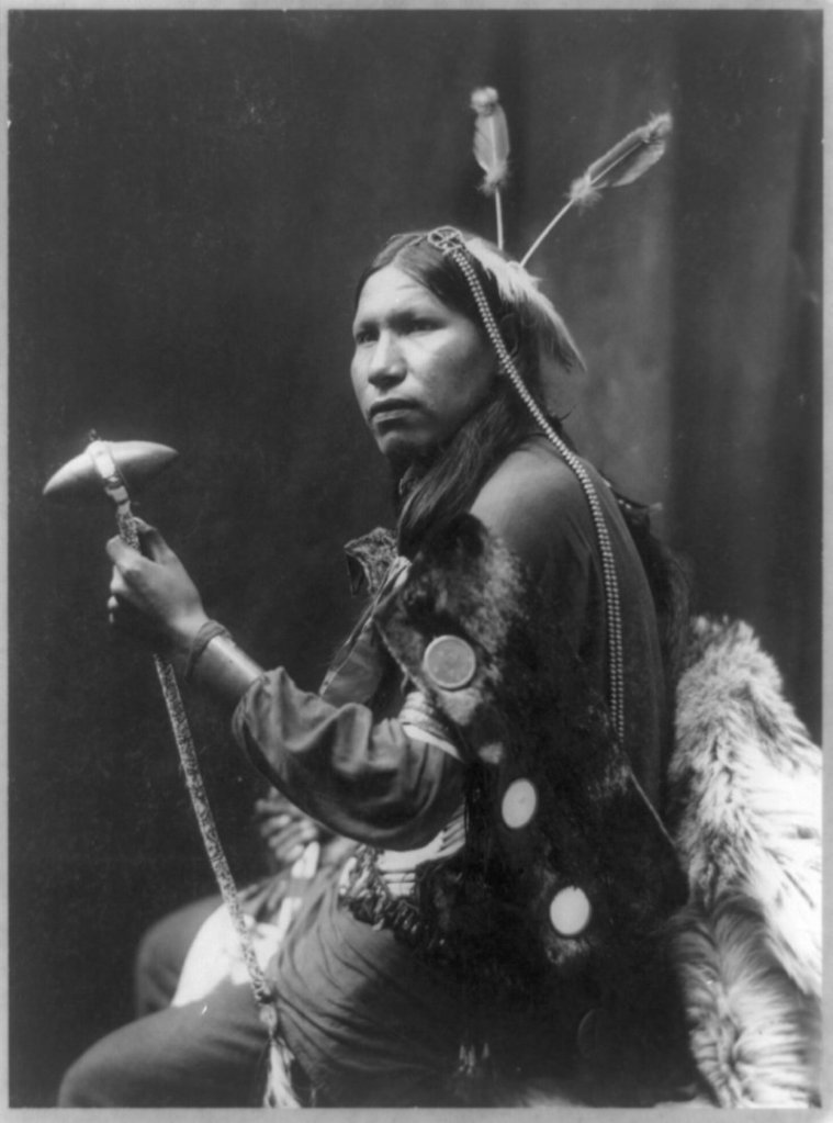This 1899 portrait by George Heyn, provided by the Library of Congress, shows Albert Afraid of Hawk holding a tomahawk while touring with Buffalo Bill’s Rough Riders.