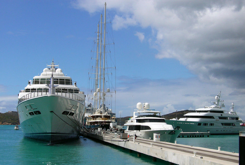The Rising Sun, a five-story super-yacht, sits at anchor next to a sailboat and smaller yachts at the Yacht Haven Grande harbor in St. Thomas, U.S. Virgin Islands in 2007. The yacht is expected to berth at the Maine State Pier later this month.