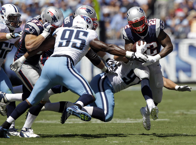 Stevan Ridley, the Patriots’ new featured running back, tries to breakaway from Kamerion Wimbley (95) and Karl Klug (97) of the Titans. Ridley rushed for 125 yards.