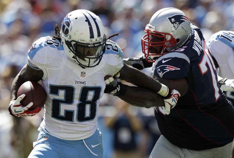 Vince Wilfork chases down Titans running back Chris Johnson, who gained just 4 yards on 11 carries Sunday against a Patriots defense rejuvenated by the addition of rookies Chandler Jones, Dont’a Hightower and Tavon Wilson.
