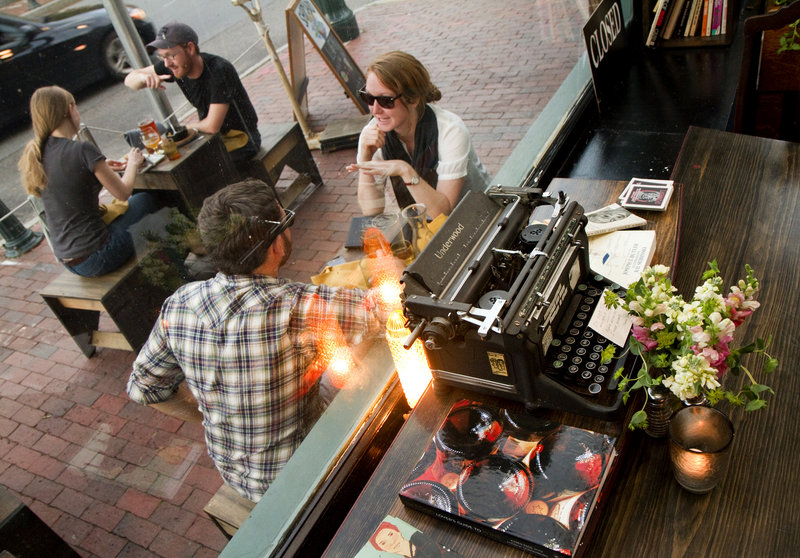Daniel Liebowitz and Ariel Solaski of Vermont enjoy streetside dining at LFK, a literary hangout decorated with a number of old typewriters and books.
