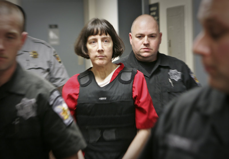 Amy Bishop is escorted through a courthouse Tuesday in Huntsville, Ala. She pleaded guilty to killing three co-workers and wounding three and is facing multiple life sentences.