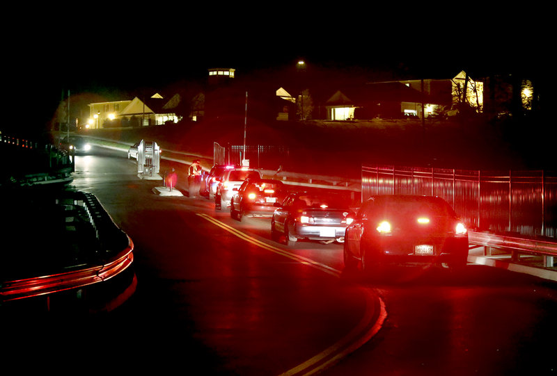 Cars line up Sept. 7 at a gate manned by security guards at The Grove, a new student housing complex in Orono that already has a reputation for partying. The previous weekend, parties drew hundreds of students and several police officers.