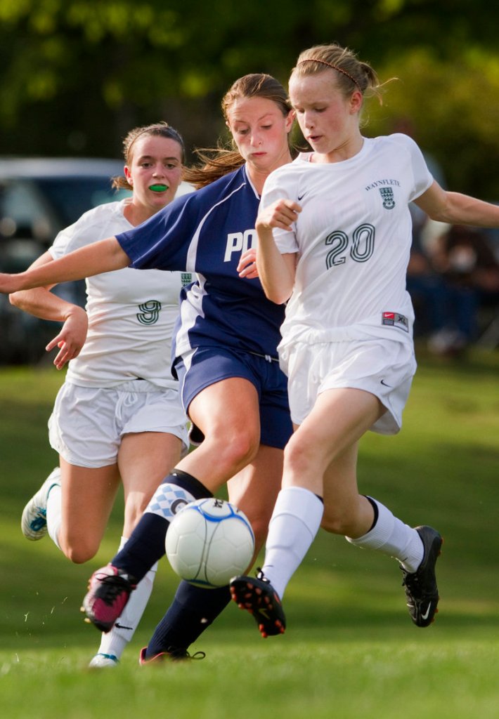 Waynflete freshman Arianna Giguere, right, attempts to keep the ball from Paxton Arsenault of Poland during their 2-2 tie in girls’ soccer Tuesday.