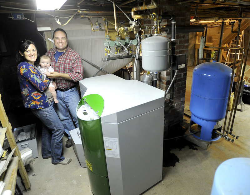 Molly and Chris Just with their six-month-old son Ben just installed this wood-pellet boiler (foreground), to replace their old oil-fired boiler. Maine's consumption of oil is steadily declining and has reached levels not seen since 1984.