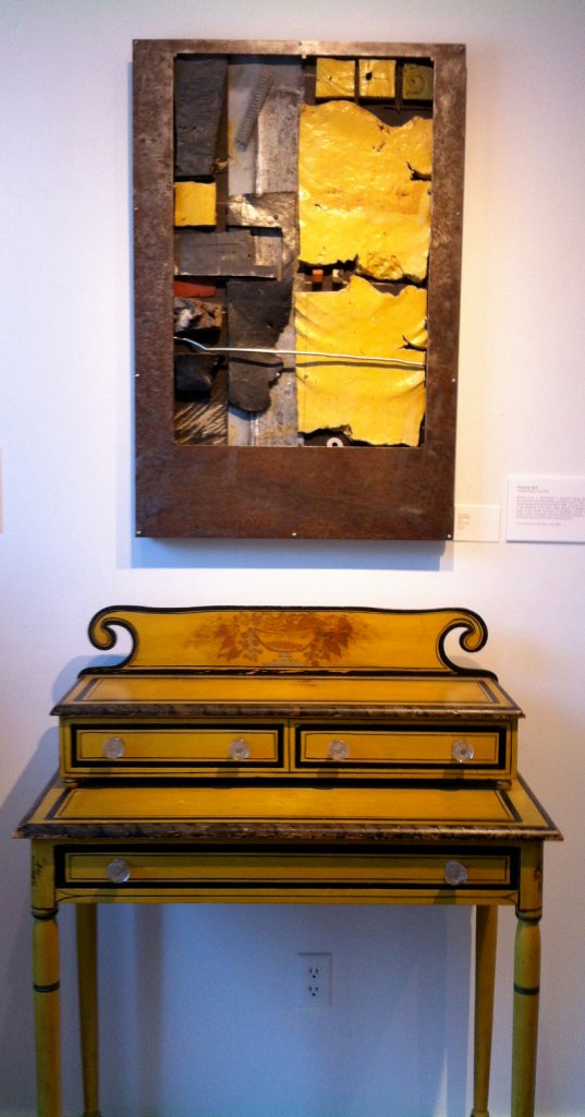 “Yellow Mesa” by New Hampshire ceramic artist Don Williams hangs above a yellow painted dresser owned by Hap Moore Antiques Auctions of York in “Accord VIII” at the George Marshall Store Gallery.