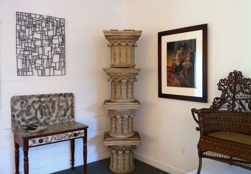 “Wall Drawing – Rocks and Trees” by Portland artist Leon Anderson hangs above a smoked grained card table from W.M. Schwind Jr. Antiques of Yarmouth. Also pictured are four stacked capitals from Smith-Zukas Antiques of Wells. To the right of the columns is a pastel painting by Kate Doyle, “The Embrace,” from “Accord VIII” at the George Marshall Store Gallery.