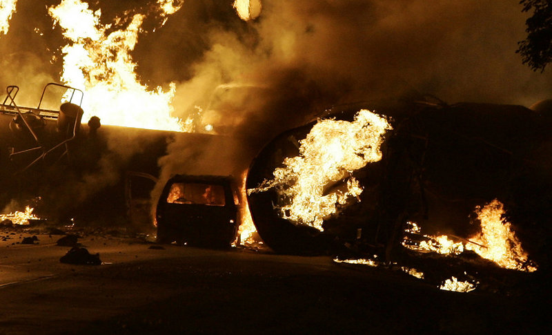 A vehicle burns near a train derailment near Rockford, Ill., in 2009. Residents were forced to evacuate after the fiery freight train derailment northwest of Chicago.