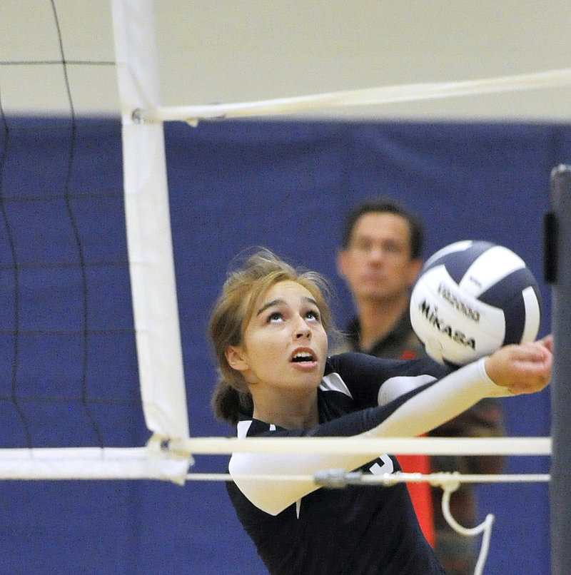 Abby Latham of Yarmouth retains her concentration while saving a ball from going out of bounds.