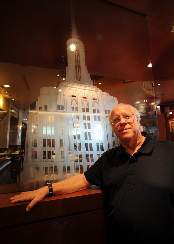 Investor Michael Caplan stands near an etched-glass panel of the Empire State Building at a Florida deli.