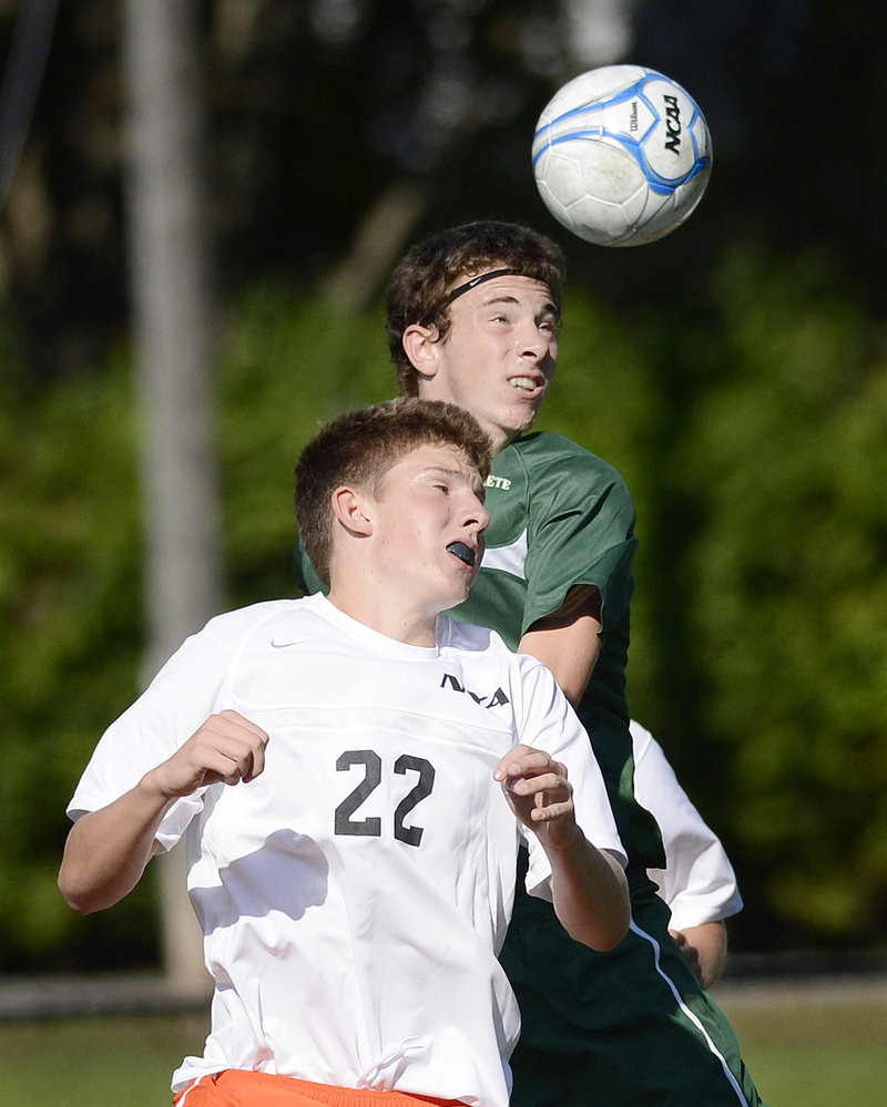 Matt Hawkins of North Yarmouth Academy goes up for a header as Jack Cutler of Waynflete challenges from behind Thursday during Waynflete’s 5-0 victory.