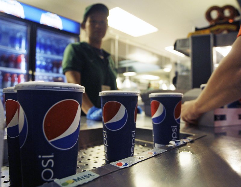 Soft drinks are sold at a baseball game in New York. Health officials approved a 16-ounce limit on sodas and other sugary drinks sold at restaurants, delis and movie theaters.